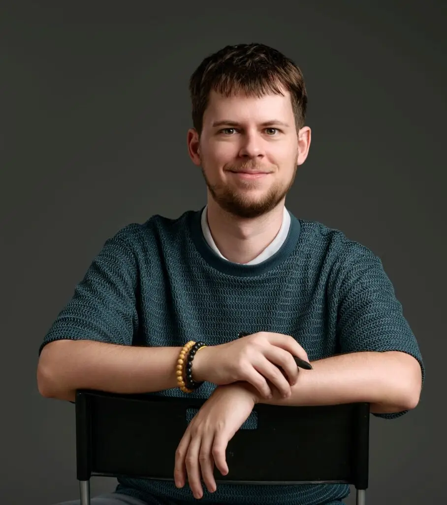 Chris Lipcsei, Internal Family Systems practitioner, sitting on a chair